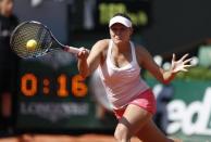 Evgeniya Rodina of Russia plays a shot to Simona Halep of Romania during their women's singles match at the French Open tennis tournament at the Roland Garros stadium in Paris, France, May 24, 2015. REUTERS/Vincent Kessler