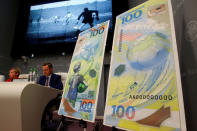 FILE PHOTO: Russian central bank deputy chairwoman Olga Skorobogatova and General Director of Goznak state firm Arkady Trachuk attend a news conference unveiling the newly designed 100-rouble banknote dedicated to the 2018 FIFA World Cup, in Moscow, Russia May 22, 2018. REUTERS/Sergei Karpukhin/File Photo