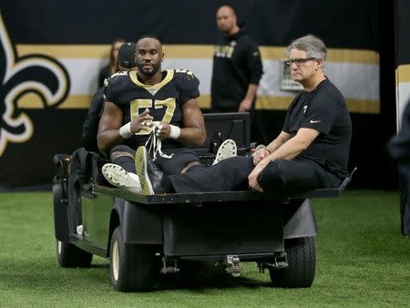 Nov 19, 2017; New Orleans, LA, USA; New Orleans Saints defensive end Alex Okafor (57) is taken off the field on a cart after an injury in the second half against the Washington Redskins at the Mercedes-Benz Superdome. The Saints won, 34-31 in overtime. Chuck Cook-USA TODAY Sports