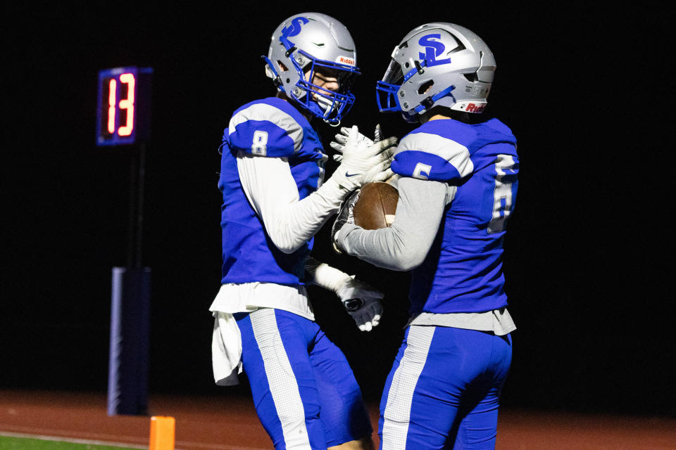 Southern Lehigh's William Knudson (6) celebrates with teammate Andrew Olesh (8) putting them up 42-12 against East Stroudsburg South in the 5A District 11 semifinals on November 3, 2023