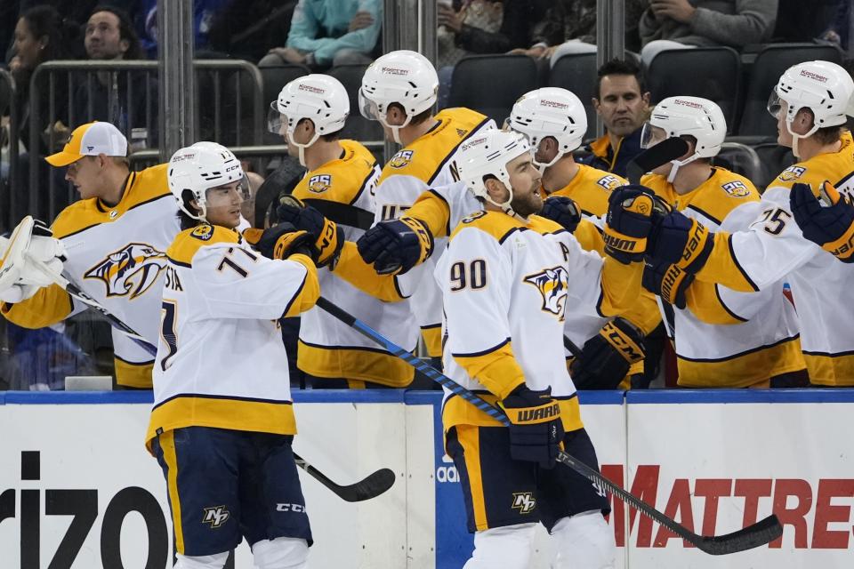 Nashville Predators' Ryan O'Reilly (90) and Luke Evangelista (77) celebrate with teammates after O'Reilly scored a goal during the second period of an NHL hockey game against the New York Rangers, Thursday, Oct. 19, 2023, in New York. (AP Photo/Frank Franklin II)