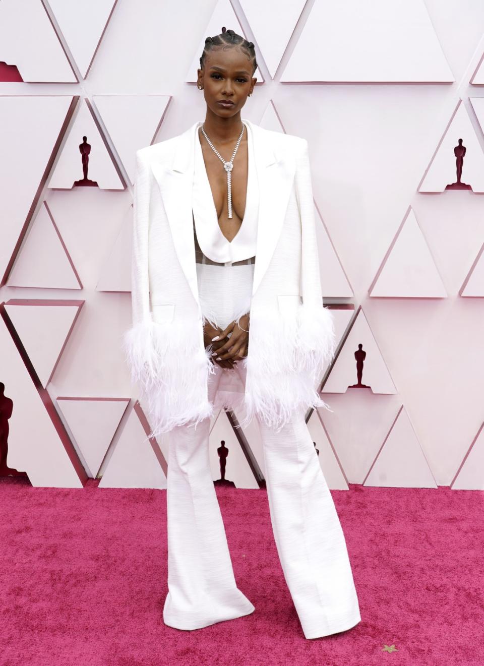 Tiara Thomas in a white pantsuit with a plunging neckline