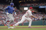 Chicago Cubs' Ian Happ, left, grounds into a double play to end the top of the third inning as St. Louis Cardinals first baseman Paul Goldschmidt handles the throw during a baseball game Friday, June 24, 2022, in St. Louis. (AP Photo/Jeff Roberson)