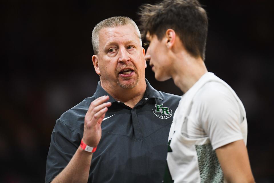 Fossil Ridge boys basketball head coach Matt Johannsen speaks with Colin Hayes during a 6A Final 4 playoff game against Regis at the Denver Coliseum on Friday, March 10, 2023, in Denver, Colo.