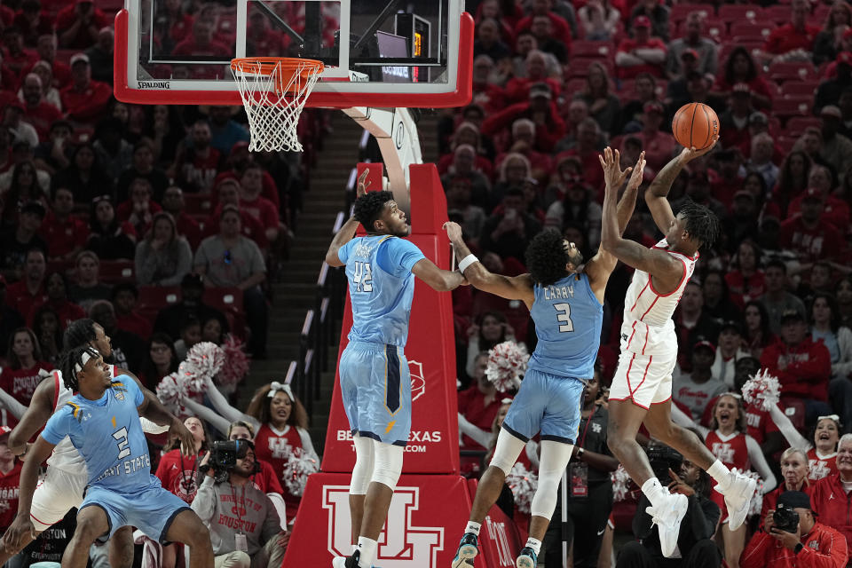 Houston guard Marcus Sasser, right, hits a basket over Kent State guard Sincere Carry (3) during the second half of an NCAA college basketball game Saturday, Nov. 26, 2022, in Houston. (AP Photo/Kevin M. Cox)