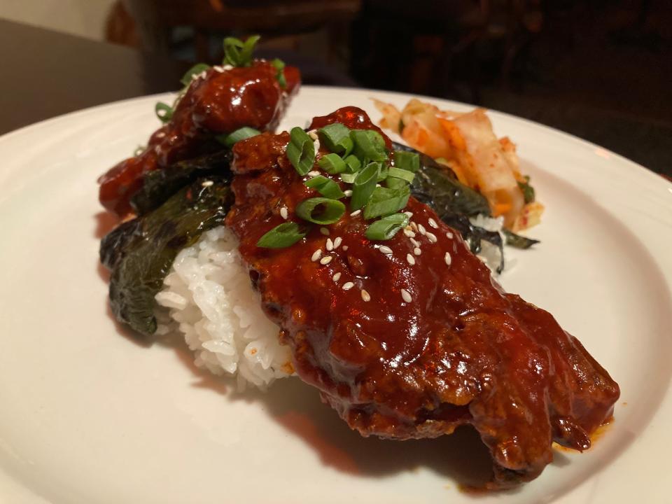 Korean fried chicken with kimchi, spicy sticky sauce, rice and a fire-roasted poblano pepper Nov. 28, 2023 at Hugo's Bar & Grill in Montpelier.