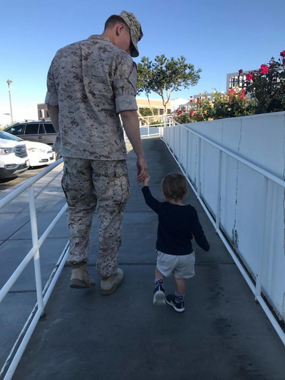 Pictured are U.S. Marine Capt. Mitchell Morton and one of his children in this undated handout photo from Tunnel to Towers Foundation. The foundation’s Gold Star Family Home Program paid off the Morton’s home mortgage after Mitchell died from cancer on Nov. 4, 2022.