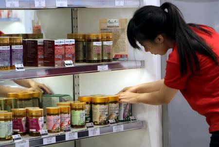 A store worker adjusts Australian products on display for sale in Sydney, Australia, January 27, 2016. Picture taken January 27, 2016. REUTERS/Jarni Blakkarly