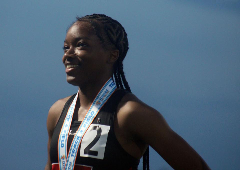 Bishop Kenny's Ka'Myya Haywood receives her gold medal on the podium after winning the girls 400-meter run.