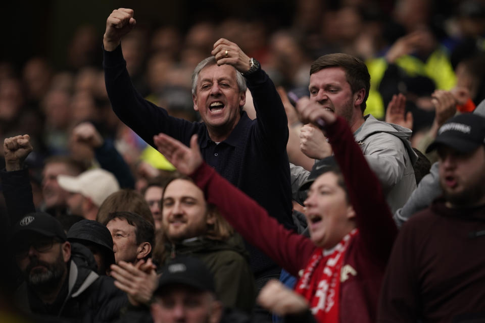 Liverpool supporters celebrate after Alexis Mac Allister scored his side's opening goal during the FA Cup quarterfinal soccer match between Manchester United and Liverpool at the Old Trafford stadium in Manchester, England, Sunday, March 17, 2024. (AP Photo/Dave Thompson)