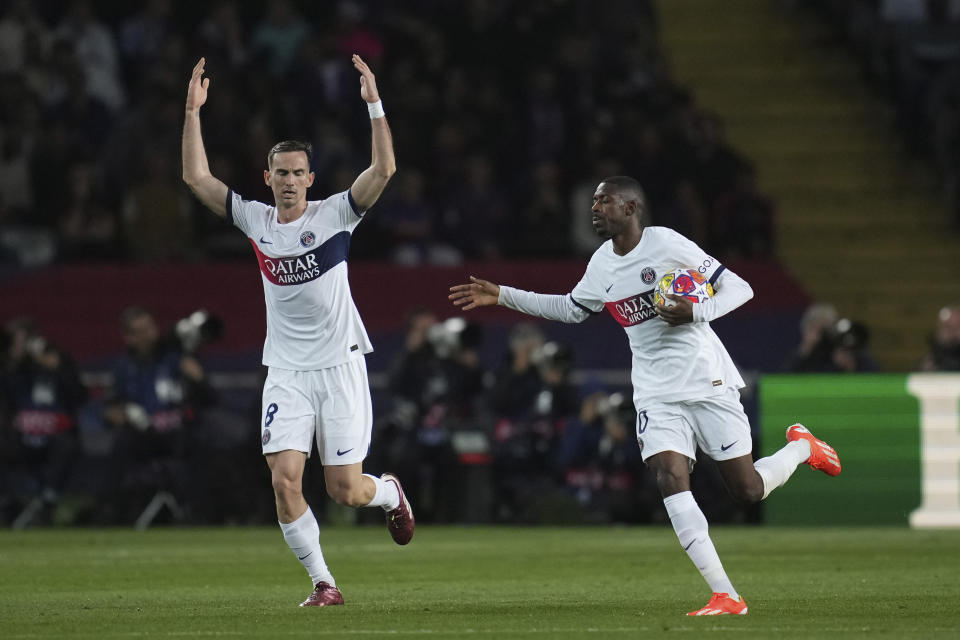 PSG's Ousmane Dembele, right, celebrates after scoring his side's opening goal during the Champions League quarterfinal second leg soccer match between Barcelona and Paris Saint-Germain at the Olimpic Lluis Companys stadium in Barcelona, Spain, Tuesday, April 16, 2024. (AP Photo/Emilio Morenatti)