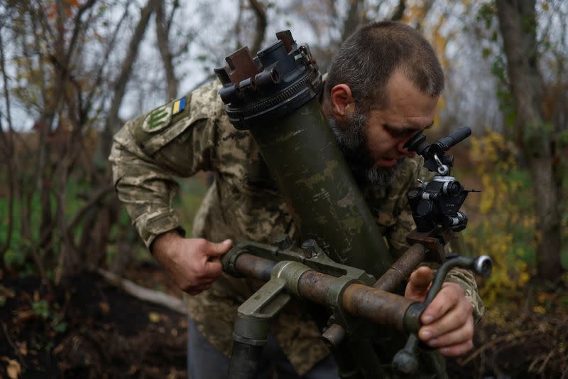 Ukrainian serviceman prepares a mortar for shelling at a position in a frontline in Mykolaiv region