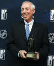FILE - In this Oct. 27, 2010, file photo, Boston College hockey coach Jerry York poses with his 2010 Lester Patrick Award trophy during a media availability in Boston. York was elected to the Hockey Hall of Fame, Tuesday, June 25, 2019. (AP Photo/Michael Dwyer, File)