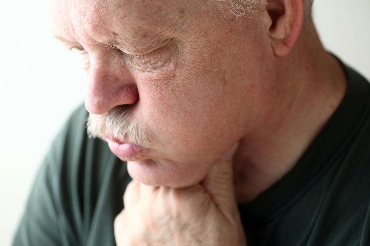 Man experiencing acid reflux or heartburn