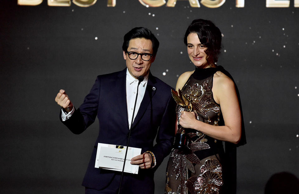 (L-R) Ke Huy Quan and Jenny Slate accept the Best Cast Ensemble award for 'Everything Everywhere All at Once' onstage during the Hollywood Critics Association's 2023 HCA Film Awards at Beverly Wilshire, A Four Seasons Hotel on February 24, 2023 in Beverly Hills, California.