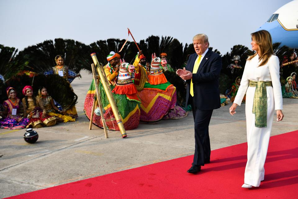 US President Donald Trump and First Lady Melania Trump are greeted by performers wearing traditional costumes as they arrive at Agra Air Base in Agra on February 24, 2020. (Photo by MANDEL NGAN / AFP) (Photo by MANDEL NGAN/AFP via Getty Images)