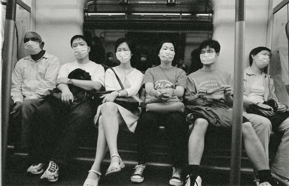 <span class="caption">From 2003, in Hong Kong, people riding the subway during the SARS outbreak.</span> <span class="attribution"><a class="link " href="https://www.gettyimages.com/detail/photo/hong-kong-people-riding-subway-during-sars-outbreak-royalty-free-image/200509489-001?adppopup=true" rel="nofollow noopener" target="_blank" data-ylk="slk:Getty Images / xPacifica;elm:context_link;itc:0;sec:content-canvas">Getty Images / xPacifica</a></span>