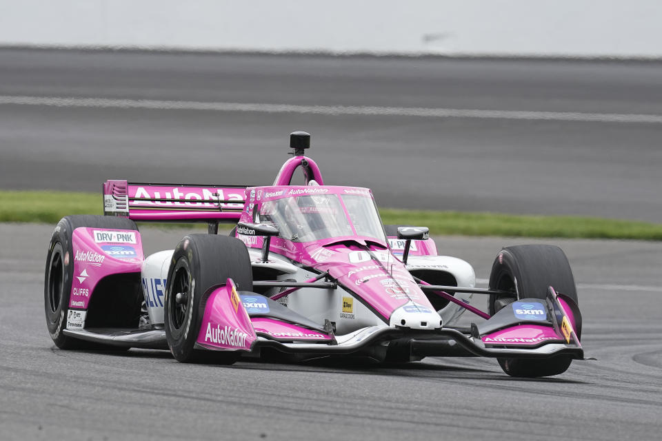 Helio Castroneves, of Brazil, drives into a turn during practice for the IndyCar Grand Prix auto race at Indianapolis Motor Speedway, Friday, May 12, 2023, in Indianapolis. (AP Photo/Darron Cummings)