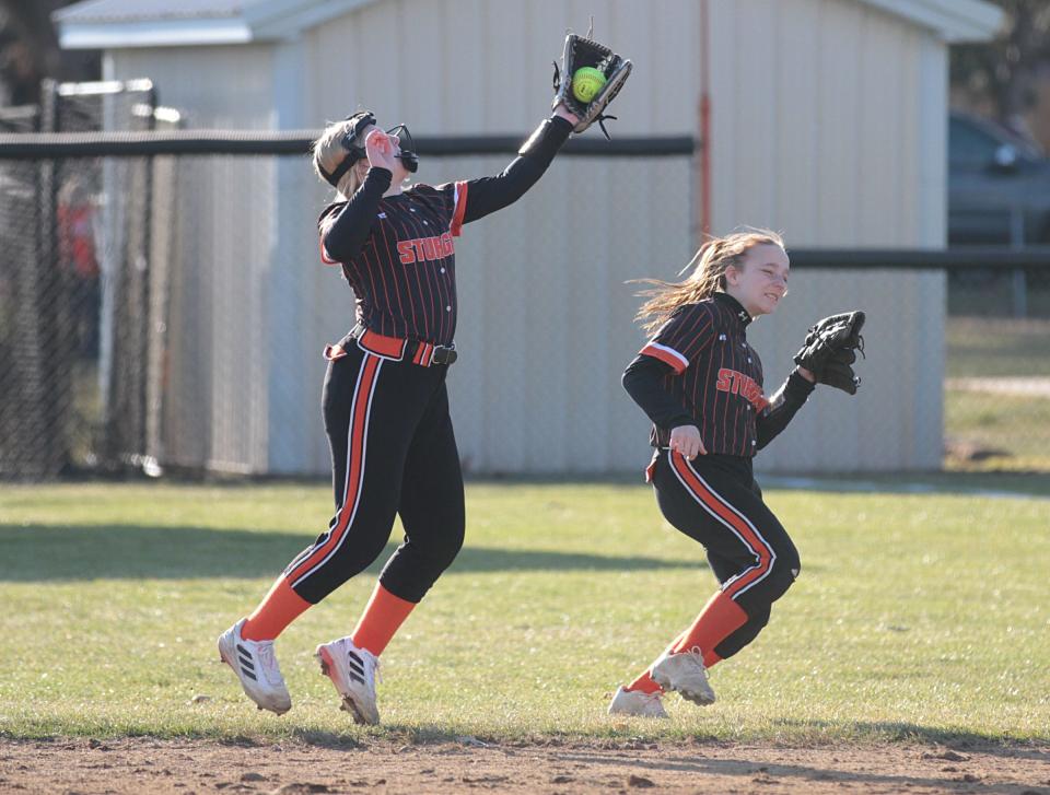 Sturgis second baseman Gracie Pagels makes a leaping catch for an out in front of teammate Kami Kimes.