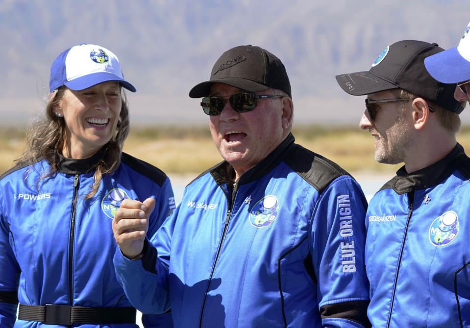 FILE - William Shatner, center, speaks as Audrey Powers, left, and Chris Boshuizen appear during a press availability at the Blue Origin spaceport near Van Horn, Texas, on Oct. 13, 2021. The "Star Trek" actor and the three fellow passengers soared to an altitude of 66.5 miles (107 kilometers) over the West Texas desert in a fully automated capsule, in a flight that lasted just over 10 minutes. (AP Photo/LM Otero, File)