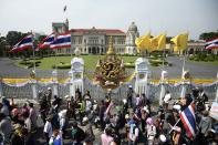 Anti-government protesters celebrate outside the grounds of Government House after demonstrations were called off in Bangkok December 3, 2013. Thailand's government ordered police to stand down and allow protesters into state buildings on Tuesday, removing a flashpoint for clashes and effectively bringing an end to days of violence in Bangkok in which five people have died. REUTERS/Dylan Martinez