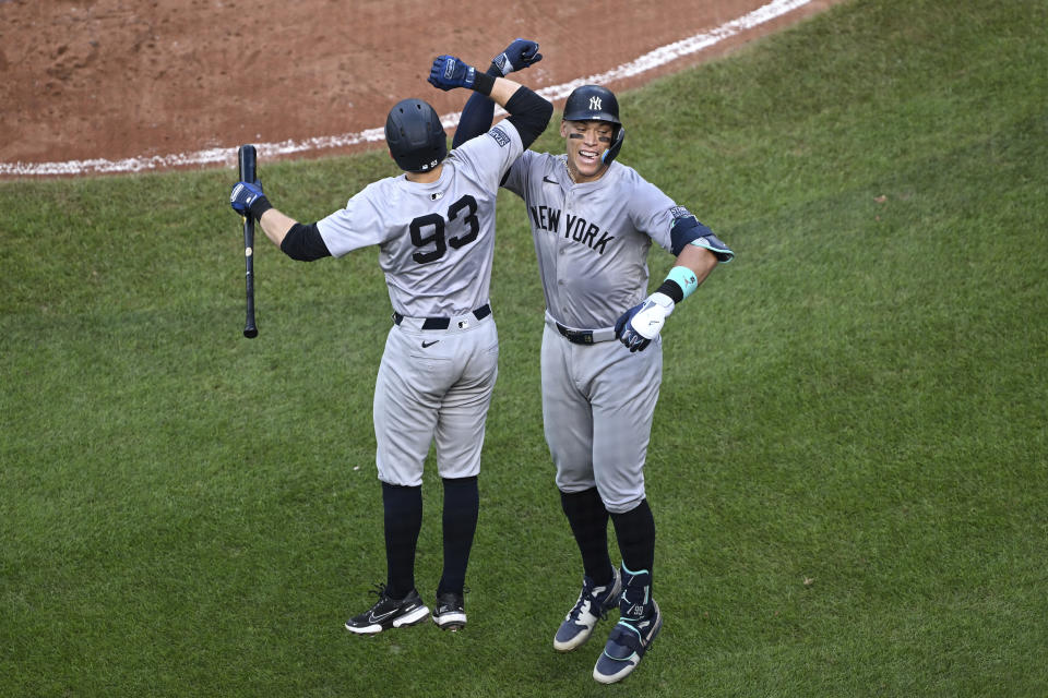 New York Yankees' Aaron Judge, right, celebrates after his solo home run with Ben Rice (93) hit off Baltimore Orioles pitcher Grayson Rodriguez during the fifth inning of a baseball game, Saturday, July 13, 2024, in Baltimore. (AP Photo/Terrance Williams)