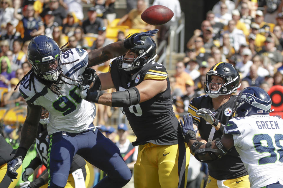 Seattle Seahawks outside linebacker Jadeveon Clowney (90) deflects a pass by Pittsburgh Steelers quarterback Ben Roethlisberger (7) as he is blocked by offensive tackle Alejandro Villanueva (78) in the first half of an NFL football game, Sunday, Sept. 15, 2019, in Pittsburgh. (AP Photo/Gene J. Puskar)