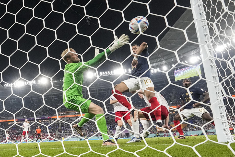 France's Kylian Mbappe scores his side's second goal during the World Cup group D soccer match between France and Denmark, at the Stadium 974 in Doha, Qatar, Saturday, Nov. 26, 2022. (AP Photo/Martin Meissner)