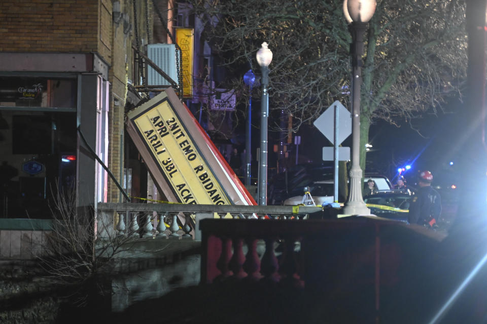 Authorities stand outside the Apollo Theatre after a severe spring storm caused damage and injuries during a concert, late Friday, March 31, 2023, in Belvidere, Ill. (AP Photo/Matt Marton)