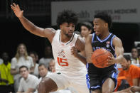 Duke guard Jeremy Roach (3) looks to ball the ball under pressure from Miami forward Norchad Omier (15) during the first half of an NCAA college basketball game, Monday, Feb. 6, 2023, in Coral Gables, Fla. (AP Photo/Marta Lavandier)