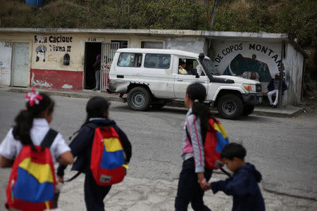 Schoolchildren walk in front of a public transport office in El Junquito, Venezuela, February 19, 2019. Picture taken February 19, 2019. To match Insight VENEZUELA-POLITICS/EVIDENCE. REUTERS/Andres Martinez Casares