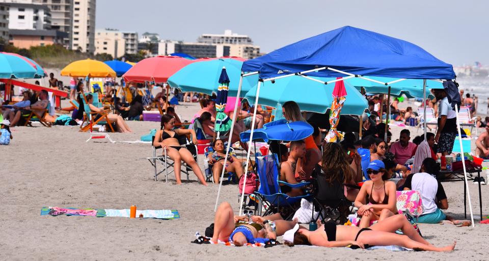 Sunbathers pack the sand off Minutemen Causeway on Saturday afternoon in downtown Cocoa Beach.