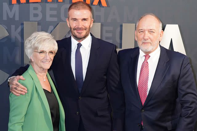 <p>Ian West/PA Images via Getty</p> David Beckham with his parents Sandra and Ted at the 'Beckham' premiere