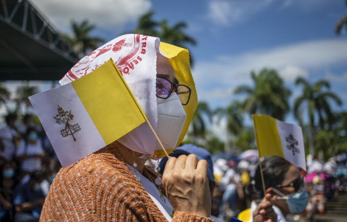 A faithful, holding a Vatican miniature flag, takes part in a procession in Managua, Nicaragua, Saturday, Aug. 13, 2022. The Catholic Church has called on the faithful to peacefully arrive at the Cathedral in Managua Saturday after National Police denied permission for a planned religious procession on “internal security” grounds. (AP Photo)
