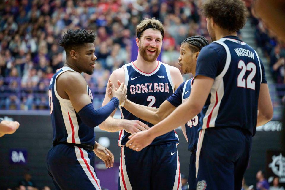 Gonzaga forward Drew Timme (2) reacts with teammates guard Malachi Smith (13), left, and guard Rasir Bolton (45) during the second half against Portland at Chiles Center.