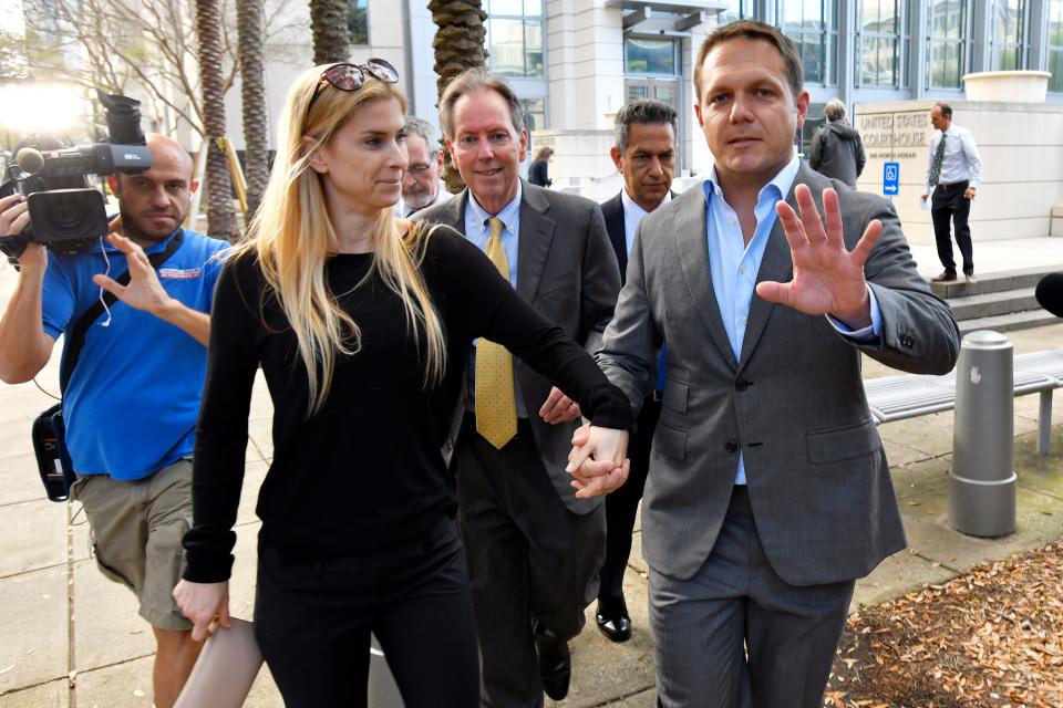 Former JEA CEO Aaron Zahn with his wife Mary Branan Ennis Zahn and attorney Brian Albritton leave the federal courthouse after Zahn posted bond on March 8, 2022