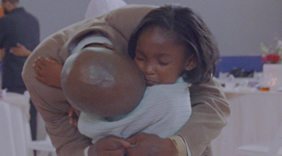 Aubrey Smith hugs her dad Keith Swepston in a still from Daughters, the new Netflix documentary that highlights a program uniting girls with their incarcerated fathers.