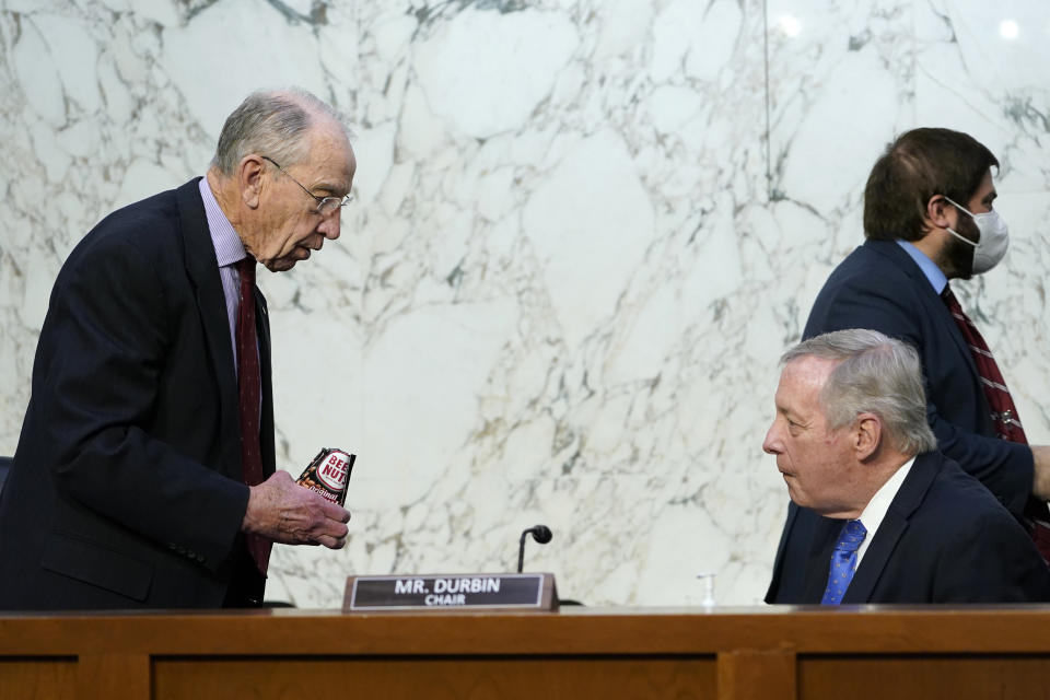 Senate Judiciary Committee chairman Sen. Dick Durbin, D-Ill., right, talks with ranking member Sen. Chuck Grassley, R-Iowa, left, before the start of a committee business meeting on Capitol Hill in Washington, Monday, March 28, 2022, regarding Supreme Court nominee Judge Ketanji Brown Jackson. (AP Photo/Susan Walsh)