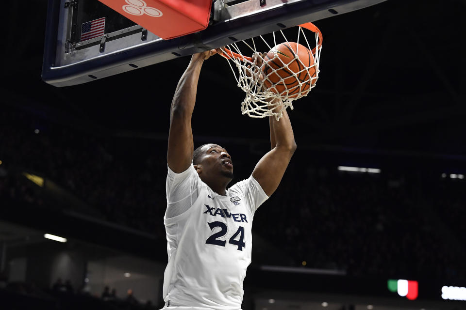 Xavier forward Abou Ousmane (24) dunks the ball during the first half of an NCAA college basketball game against the Marquette in Cincinnati, Saturday, March 9, 2024. (AP Photo/Timothy D. Easley)