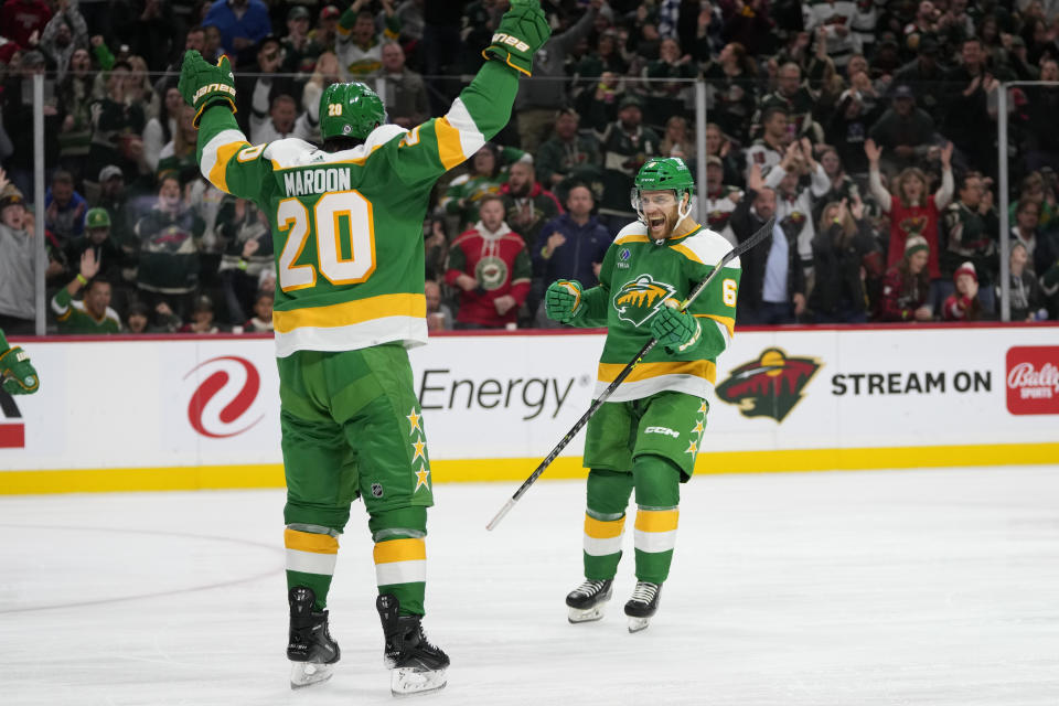 Minnesota Wild defenseman Dakota Mermis (6), right, celebrates after scoring during the second period of an NHL hockey game against the Columbus Blue Jackets, Saturday, Oct. 21, 2023, in St. Paul, Minn. (AP Photo/Abbie Parr)