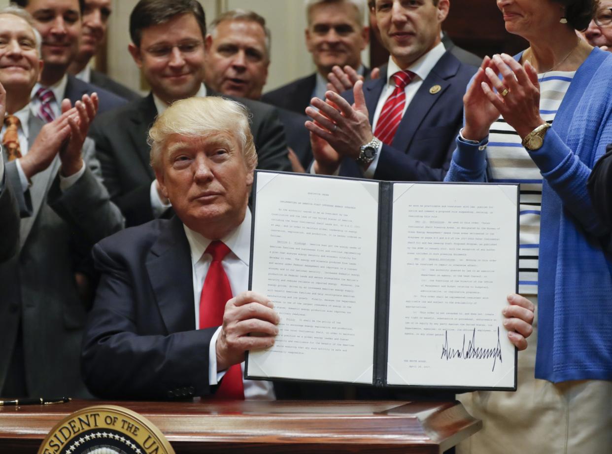 U.S. President Donald Trump displays an Executive Order on 