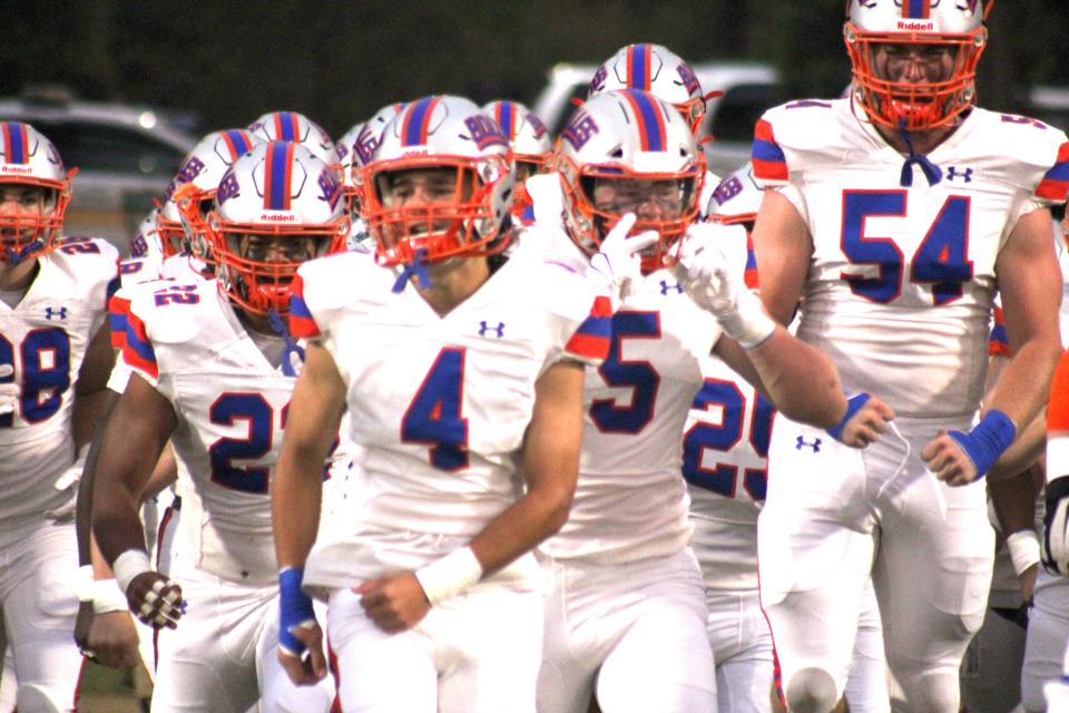 Bolles players race onto the field before their Sept. 16 game against Trinity. The Bulldogs face Bishop Kenny on Friday for the District 2-2M football championship.
