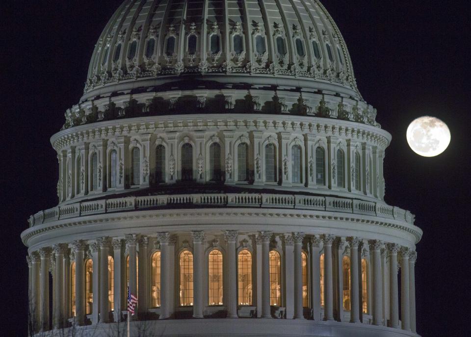 The moon rises behind the U.S. Capitol Dome in Washington as Congress worked into the late evening, Sunday, Dec. 30, 2012 to resolve the stalemate over the pending "fiscal cliff." (AP Photo/J. David Ake)