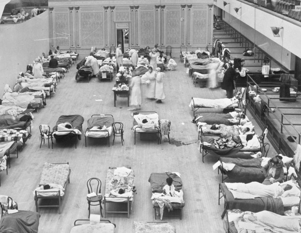 FILE - In this 1918 file photo made available by the Library of Congress, volunteer nurses from the American Red Cross tend to influenza patients in the Oakland Municipal Auditorium, used as a temporary hospital. Woodrow Wilson did not address the nation on the subject of the pandemic of 1918-19 a single time, he did not call for Congress to act and he did not summon the nation to come together. (Edward A. "Doc" Rogers/Library of Congress via AP, File)