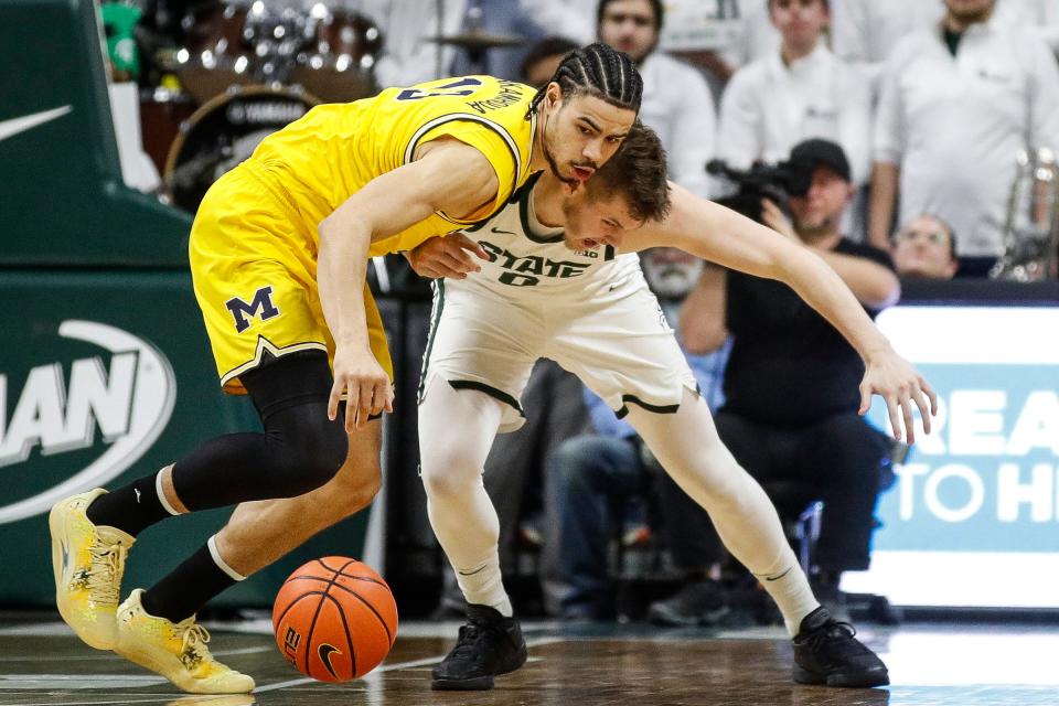 Michigan forward Olivier Nkamhoua (13) and Michigan State forward Jaxon Kohler (0) battle for the ball during the first half at Breslin Center in East Lansing on Tuesday, Jan. 30, 2024.