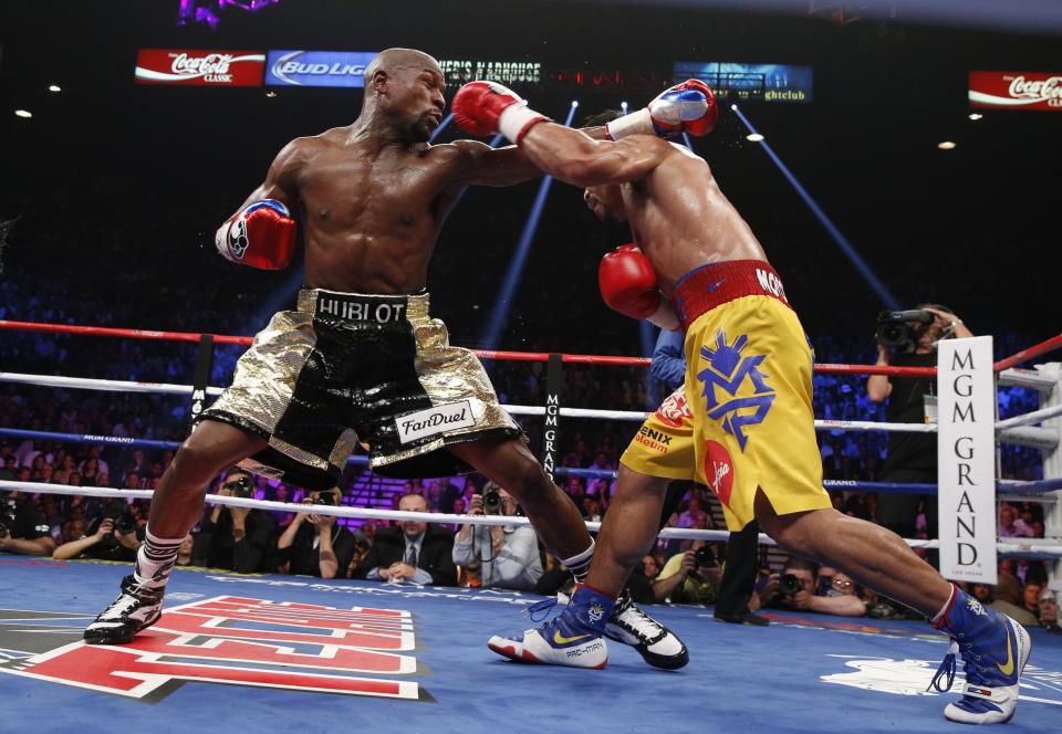 Floyd Mayweather Jr. exchange punches with Manny Pacquiao.