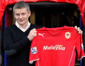 FILE PHOTO: Football Soccer - Cardiff City unveil Ole Gunnar Solskjaer as their Manager - Cardiff City Stadium, Cardiff, Britain - 2 January, 2014 Former Manchester United striker Ole Gunnar Solskjaer holds a club shirt as he is officially unveiled as the new manager of English Premier League soccer team Cardiff City. REUTERS/Rebecca Naden / File Photo