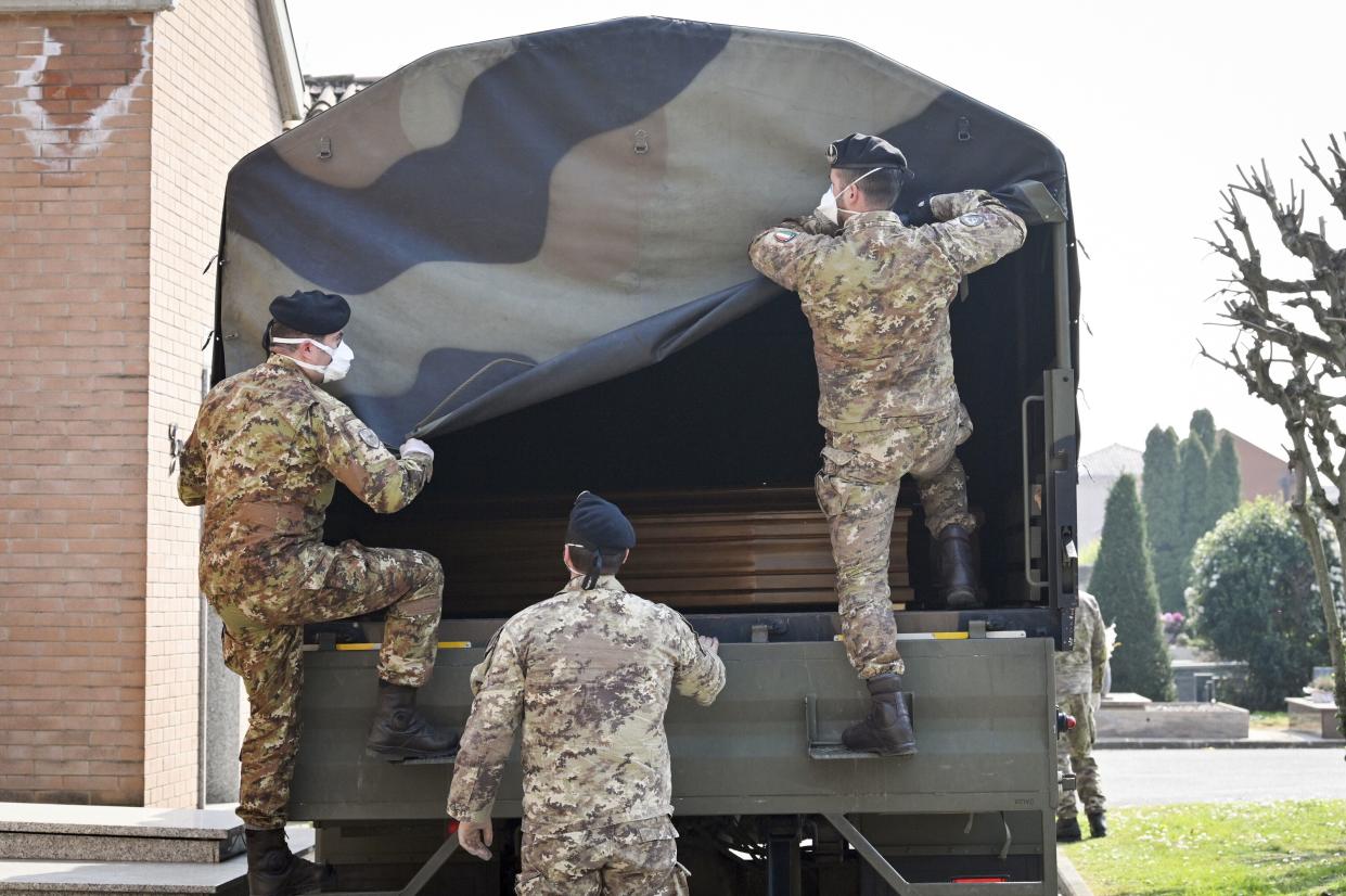 A convoy of Italian Army trucks arrives from Bergamo carrying bodies of coronavirus victims to the cemetery of Ferrara, Italy, where they will be cremated, on Saturday, March 21, 2020. The transfer was made necessary since Bergamo mortuary reached maximum capacity. For most people, the new coronavirus causes only mild or moderate symptoms.