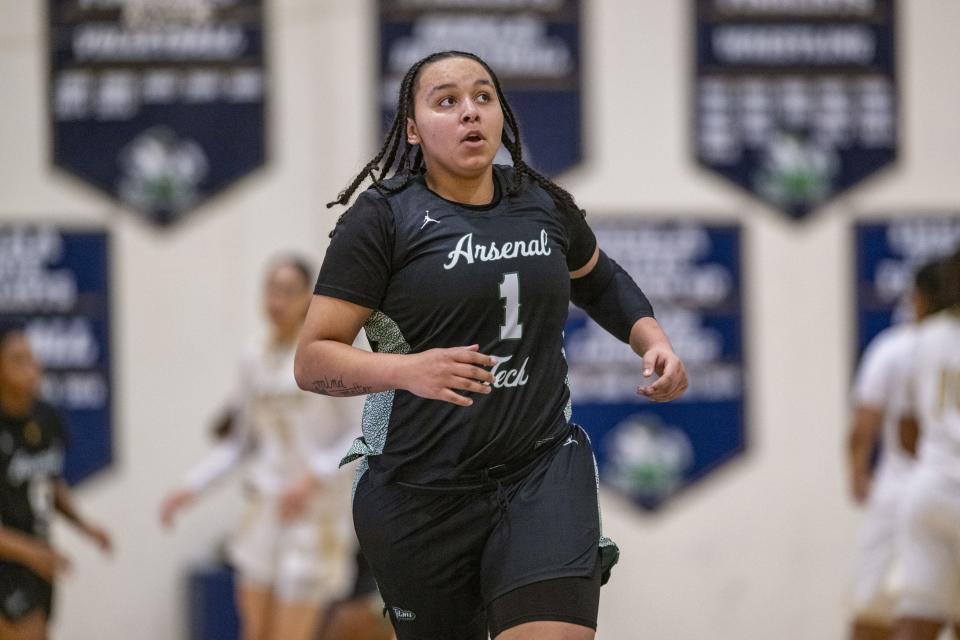 Indianapolis Arsenal Technical High School senior Kayla Lacombe (1) glances at the scoreboard after scoring during the first half of an IHSAA Class 4A Sectional semi-final basketball game against Warren Central High School, Friday, Feb. 2, 2024, at Cathedral High School.