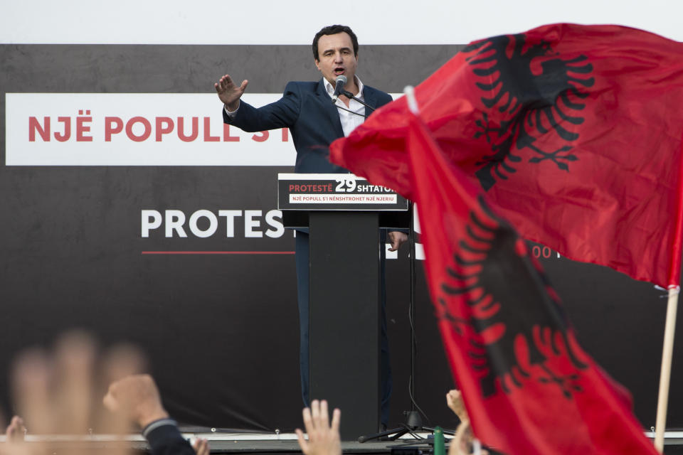 Leader of Kosovo's opposition Self-Determination party Albin Kurti, holds a speech during a protest as opposition supporters wave national Albanian flags in the Skanderbeg Square on Saturday, Sept. 29, 2018, in Kosovo capital Pristina. Thousands of people in Kosovo are protesting their president's willingness to include a possible territory swap with Serbia in the ongoing negotiations to normalize relations between the two countries.(AP Photo/Visar Kryeziu)